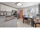 Bright kitchen with stainless steel appliances, granite countertops, and a dining table with seating at 7311 N Dartmouth Ave, Tampa, FL 33604