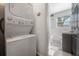 Convenient laundry area with stacked washer and dryer next to a bathroom at 7311 N Dartmouth Ave, Tampa, FL 33604