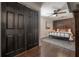 Stylish main bedroom with a decorative accent wall, ceiling fan, and large closet at 7311 N Dartmouth Ave, Tampa, FL 33604
