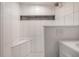 Tiled shower with a built-in bench and a convenient storage niche at 7311 N Dartmouth Ave, Tampa, FL 33604