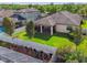 Aerial view highlights a home with a fenced yard, screened lanai, and meticulous landscaping at 8248 Sequester Loop, Land O Lakes, FL 34637