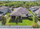 An aerial view shows the home's fenced backyard and screened-in lanai, nestled among mature trees at 8248 Sequester Loop, Land O Lakes, FL 34637