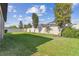 The home boasts a spacious, grassy backyard surrounded by a white fence and mature landscaping at 8248 Sequester Loop, Land O Lakes, FL 34637