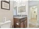 Well-lit half bathroom with granite countertops at 8248 Sequester Loop, Land O Lakes, FL 34637