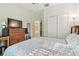 Comfortable bedroom with a wooden dresser and closet at 8248 Sequester Loop, Land O Lakes, FL 34637