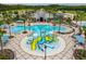 A resort-style community pool with splash pad, lounge chairs, landscaping, and recreational facility at 8248 Sequester Loop, Land O Lakes, FL 34637