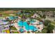 An aerial view showcases a large pool, splash pad, tennis courts and landscaping at the community center at 8248 Sequester Loop, Land O Lakes, FL 34637