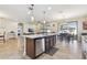 Kitchen island with stainless appliances, tile backsplash and tiled flooring at 8248 Sequester Loop, Land O Lakes, FL 34637