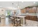Well-lit kitchen with a center island, pendant lights and stainless steel appliances at 8248 Sequester Loop, Land O Lakes, FL 34637