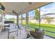 Comfortable screened lanai with ceiling fan, view of landscaped backyard and seating for relaxing and grilling at 8248 Sequester Loop, Land O Lakes, FL 34637