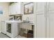 Laundry room featuring white cabinets and stainless steel sink at 8248 Sequester Loop, Land O Lakes, FL 34637