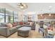 Bright living room with a ceiling fan and a view into the dining area at 8248 Sequester Loop, Land O Lakes, FL 34637