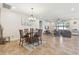 Open concept living area with dining space, a ceiling fan and large windows at 8248 Sequester Loop, Land O Lakes, FL 34637