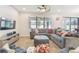 Cozy living room with a large gray sectional, tile flooring, and a ceiling fan at 8248 Sequester Loop, Land O Lakes, FL 34637