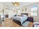 Relaxing bedroom with a ceiling fan, light-colored walls, and wood flooring at 8248 Sequester Loop, Land O Lakes, FL 34637