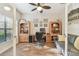 Bright office featuring built-in shelving, a ceiling fan, and a comfortable seating area at 8248 Sequester Loop, Land O Lakes, FL 34637