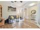 Cozy seating area in the office featuring a grey couch and doorway leading to the foyer at 8248 Sequester Loop, Land O Lakes, FL 34637