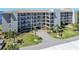 Overhead view of condos with winding drive and mature tropical trees at 8251 Brent St # 941, Port Richey, FL 34668