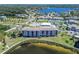 A waterfront condominium complex features lush landscaping, tennis courts, and a community pool at 8251 Brent St # 941, Port Richey, FL 34668