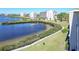 Scenic view of community lake, manicured lawn, and sidewalk at 8251 Brent St # 941, Port Richey, FL 34668