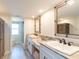 Bright bathroom with double sink vanity, granite counters, with views to the bathroom at 8251 Brent St # 941, Port Richey, FL 34668