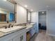 Bright bathroom with double sink vanity, granite counters, with views to the walk-in closet at 8251 Brent St # 941, Port Richey, FL 34668
