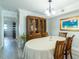 Dining room with light gray flooring, wood table, hutch, and view into the hallway at 8251 Brent St # 941, Port Richey, FL 34668