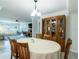 Dining room with light gray flooring, wood table, hutch, and view into the living room at 8251 Brent St # 941, Port Richey, FL 34668