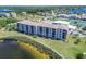 Exterior aerial view of a well-maintained condo community overlooking a tranquil lake at 8251 Brent St # 941, Port Richey, FL 34668