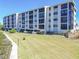Scenic view of exterior of condo with beautifully manicured lawn and sidewalks at 8251 Brent St # 941, Port Richey, FL 34668
