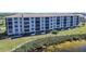 The exterior aerial image showcases a multi-story condo community with manicured lawns and landscaping at 8251 Brent St # 941, Port Richey, FL 34668