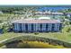 Exterior aerial image of waterfront condominiums with well-manicured landscaping and lakeside views at 8251 Brent St # 941, Port Richey, FL 34668