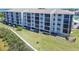 Exterior aerial image of a multi-story condominium building showcasing its well-kept landscaping at 8251 Brent St # 941, Port Richey, FL 34668