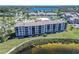 Exterior aerial view of waterfront condominium with well-manicured landscaping and lakeside views at 8251 Brent St # 941, Port Richey, FL 34668