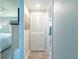 Hallway view with a closet, leading to a bedroom and bathroom with modern updates at 8251 Brent St # 941, Port Richey, FL 34668
