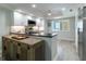 Modern kitchen featuring white cabinets, granite countertops, stainless steel appliances, and a breakfast bar with an island at 8251 Brent St # 941, Port Richey, FL 34668