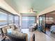 Inviting lanai with comfortable seating, ceiling fan, and serene waterfront views at 8251 Brent St # 941, Port Richey, FL 34668