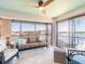 Cozy lanai with comfy seating, ceiling fan, and scenic waterfront and building views at 8251 Brent St # 941, Port Richey, FL 34668