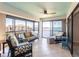 Relaxing sunroom with comfortable seating, ceiling fan, and stunning ocean views at 8251 Brent St # 941, Port Richey, FL 34668
