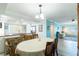 Open concept living space features kitchen, dining room, and living room with stylish decor and light gray flooring at 8251 Brent St # 941, Port Richey, FL 34668
