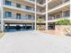 Covered parking area under condo building, providing shade for residents' vehicles at 8251 Brent St # 941, Port Richey, FL 34668