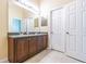 Modern bathroom with double vanity and sinks, stone countertop and tiled floors at 8341 Shallow Creek Ct, New Port Richey, FL 34653