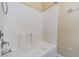 Bathroom with white tiled tub and shower features a rainfall shower head at 8341 Shallow Creek Ct, New Port Richey, FL 34653
