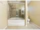 Bathroom with sliding glass shower door and tiled shower with bathtub at 8341 Shallow Creek Ct, New Port Richey, FL 34653