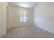Neutral carpeted bedroom offers bright natural light through shuttered window at 8341 Shallow Creek Ct, New Port Richey, FL 34653
