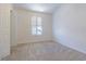 Neutral carpeted bedroom offers bright natural light through shuttered window at 8341 Shallow Creek Ct, New Port Richey, FL 34653
