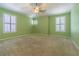 Light and airy bedroom with a ceiling fan, carpeted floor, and bright windows at 8341 Shallow Creek Ct, New Port Richey, FL 34653