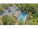 Aerial view of the community pool with lounge chairs and a recreation center near parking at 8341 Shallow Creek Ct, New Port Richey, FL 34653