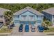 Aerial front view of multi-Gathering units with car parking, landscaping and palm trees at 8341 Shallow Creek Ct, New Port Richey, FL 34653