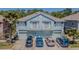 Aerial view of the exterior elevation of the multi-Gathering units with car parking and landscaping at 8341 Shallow Creek Ct, New Port Richey, FL 34653